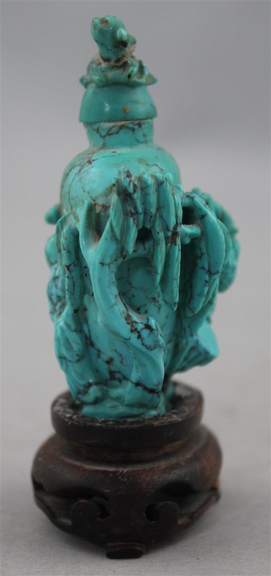 A Chinese turquoise matrix snuff bottle, late 19th / early 20th century, 6.5cm., wood stand, repair to cover